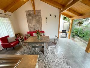 a living room with a wooden table and chairs at Ibolya Apartman in Csisztapuszta