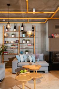 a living room with a couch and a table at Rigas Boutique Hotel & Spa in Afitos