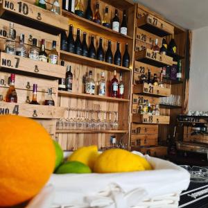 a bar with bottles of alcohol on the wall at CASA GRINDA in Sibiu