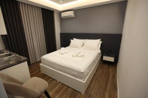 a small room with a bed and a chair at Vila Neli in Ksamil