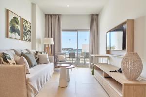 a living room with a couch and a table at Can Salia in San Antonio Bay
