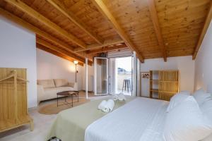 a bedroom with a large bed and a couch at Amazing View Family Penthouse in Nafplio
