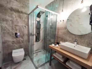 a bathroom with a sink and a shower at Liberty of Nafplio in Nafplio
