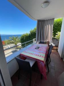 a balcony with a table and chairs and the ocean at Apartment Adriana in Opatija