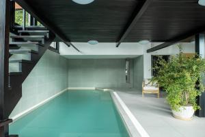 a swimming pool in the middle of a house at Mr Görgey Art Hotel & Spa in Visegrád