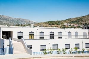 a white building with a staircase on it at B&B Boutique Eluize in Dubrovnik