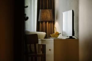 a desk with a mirror and a computer monitor on it at Landgasthof Bären in Madiswil