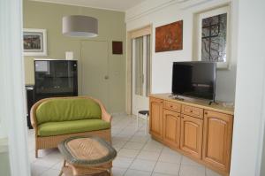un soggiorno con TV e sedia di Gallipoli Apartment ActiveLife a Gallipoli