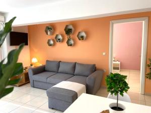 a living room with a couch and a table at Irini Apartments in Kavála