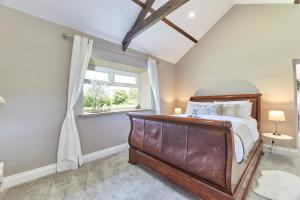 a bedroom with a large bed and a window at Host & Stay - The Pepper Pot in Alnwick
