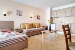 a living room with a couch and a table at Antigone Thassos Hotel in Limenas