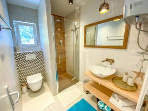 a bathroom with a toilet and a sink and a shower at Eco Sunshine Apartments Lumbarda in Lumbarda