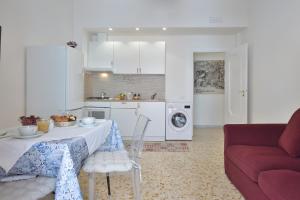 a kitchen and living room with a table and a couch at Casa Real in Minori