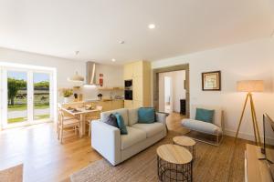 a living room with a couch and a table at Linden Tree House A and B in Caldelas