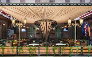 a restaurant with tables and chairs and a large ceiling at Central Hotel Yerevan in Yerevan