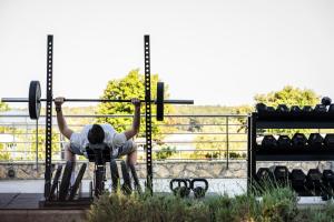 a person lifting a barbell on a fence at Falkensteiner Hotel Park Punat in Punat