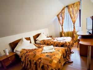 una camera d'albergo con due letti e un lavandino di Bucura Vila Sinaia - Self Service BBQ, Outdoor Hot Tub & Playground a Sinaia