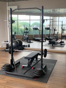 a gym with a lot of treadmills and weights at Grand Hôtel de Nîmes 4 étoiles in Nîmes