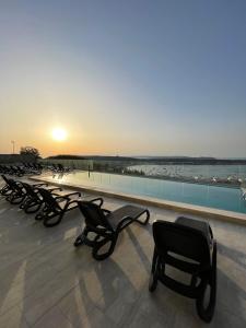 a row of chairs sitting on top of a building at Hotel VIU57 in Mellieħa