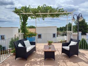 a patio with two chairs and a table at Hotel Resort Nuraghe Arvu in Cala Gonone