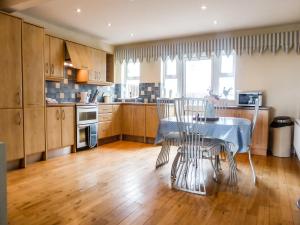 a kitchen with a table and chairs in it at Beach View in Duncannon