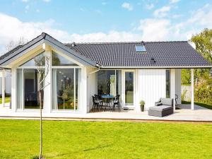 a house with a conservatory with a table at 7 person holiday home in Slagelse in Slagelse