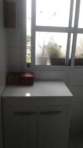 a kitchen with a white counter and a window at Andy Apto Menino Deus/Cidade Baixa/Orla in Porto Alegre +28 photos