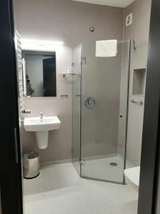 a bathroom with a shower and a sink at blue hotel in Kalisz +20 photos