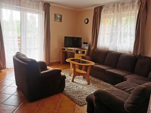 a living room with a couch and a table at Katica Ház in Zánka