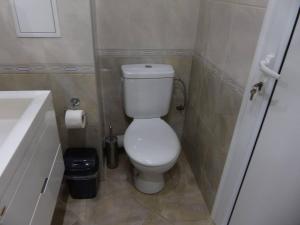 a small bathroom with a toilet and a sink at Apartament HOLIDAY in Burgas City +17 photos