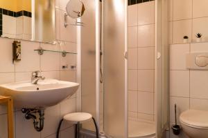 a bathroom with a sink and a shower at Ferienresidenz Schlossblick in Quedlinburg +65 photos