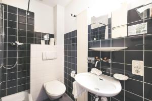 Koupelna v ubytování Hotel Alpina