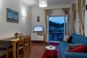a living room with a blue couch and a table at House Daniva in Okuklje