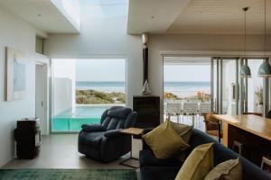 a living room with a view of the ocean at Graaitjie in Paternoster