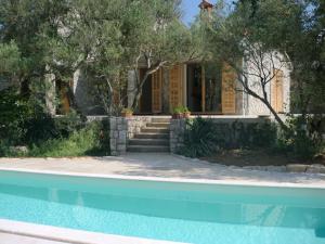 a house with a swimming pool in front of a house at Villa Splendissima Krk - Adults only in Krk