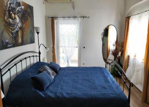 a bedroom with a blue bed and a window at Apartments 4M in Kostrena +68 photos