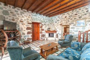 a living room filled with furniture and a stone wall at La Bella Tuineje in Tuineje