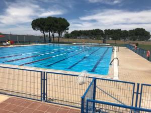 a large swimming pool with blue water at Castillo de Orgaz gratis la entrada y cerca del Puy du Fou hoy! in Manzaneque