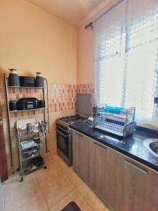 a kitchen with a stove and a sink at Nice appartement à Marrakech in Marrakesh
