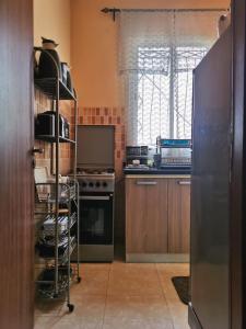 a kitchen with wooden cabinets and a stove top oven at Nice appartement à Marrakech in Marrakesh