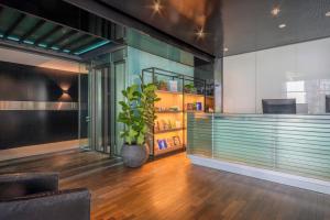 a lobby with a plant in a room at INNSiDE by Meliá Düsseldorf Seestern in Düsseldorf