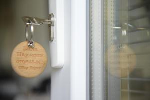 a key chain with a door tag on a window at Apartments Villa Naumovi in Star Dojran +99 photos