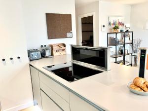 a kitchen with a counter top with a tv on it at Apartment Twelve in Shrewsbury