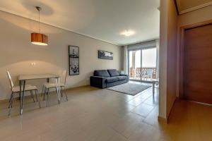 a living room with a table and a couch at Apartamento Vista Roja La Tejita in Granadilla de Abona