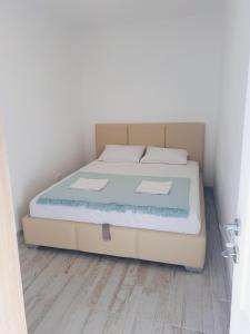 a bed in a room with a wooden floor at Apartment Jovana in Igalo
