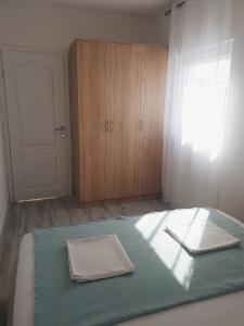 a bedroom with a bed with a window and a door at Apartment Jovana in Igalo