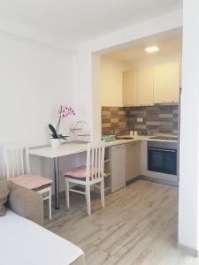 a kitchen with a table and chairs in a room at Apartment Jovana in Igalo