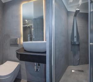 a bathroom with a sink and a shower at Akasha Suite III in Vathi