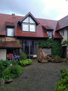 a house with a red roof and a yard at Oase der Geborgenheit in Venningen