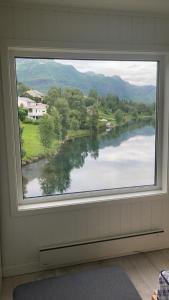 a window in a room with a view of a river at House on the lake in Bogen